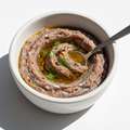Anchovies minced in bowl on white background