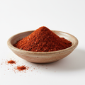 Aleppo pepper flakes in bowl on white background