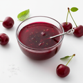Cherry vinegar dressing in glass bowl on white background