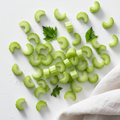 Fresh celery rib chopped on white background