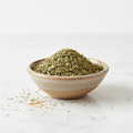 Dried oregano herb in bowl on white background